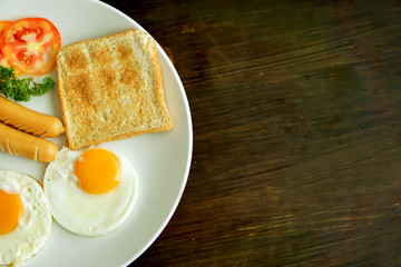 Fototapeta premium Top view of American breakfast on dark brown wooden table.