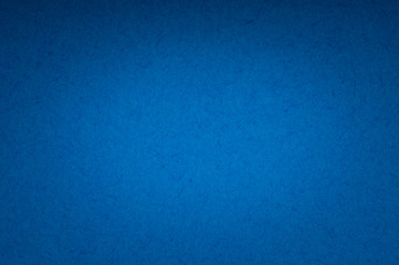 blue flat color paper sheet with light accent in the middle, vignetted background