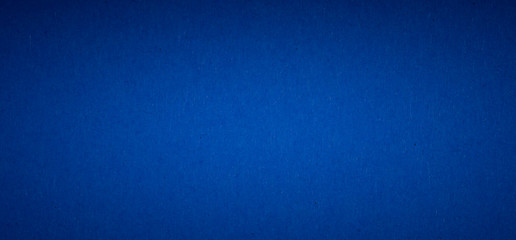 blue flat color paper sheet with light accent in the middle, vignetted background