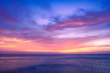 Fototapeta na wymiar Colorful sunset sky over the ocean with dramatic cloud formation