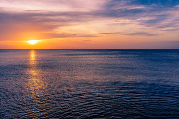 Colorful sunset sky over the ocean with dramatic cloud formation