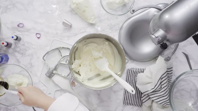 Step by step. Mixing ingredients in standing kitchen mixer to make buttercream frosting.
