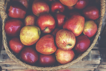 Organic fresh agricultural product at farmer market. Ripe organic apples in a basket at a farmers market.