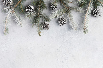 Christmas background with decorations and gift boxes on grey textured board or table
