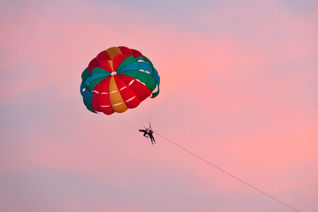 Tourists parasailing during sunset. Goa, India