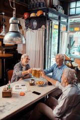 Men enjoying the evening while drinking beer together