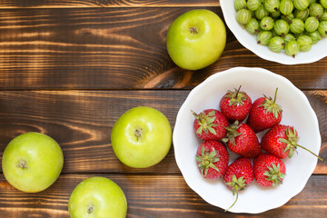 Fruits and berries in wooden table with copy space. Top view.