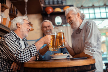 Best friends feeling cheerful while drinking beer