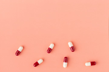 Scattering of red and white drug capsules