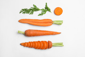 Tasty ripe carrots and leaves isolated on white, top view