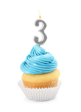 Birthday cupcake with number three candle on white background