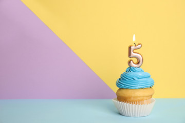 Birthday cupcake with number five candle on color background, space for text