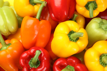 Fresh ripe colorful bell peppers as background, top view