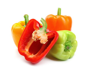 Whole and cut ripe bell peppers on white background