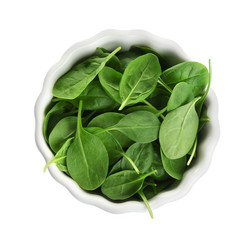 Bowl of fresh green healthy baby spinach on white background, top view