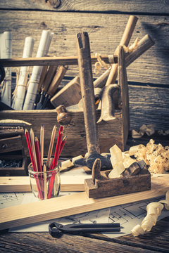 Old carpentry workbench and drawing workshop on rustic wooden table