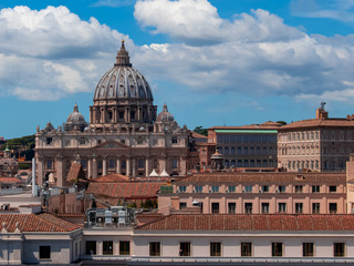 Fototapeta na wymiar Beautiful aerial view on the St. Peter's Basilica ( Famous Roman landmark ) and ancient classical buildings of the Vatican on background of clouds. City of Rome. Italy. Europe