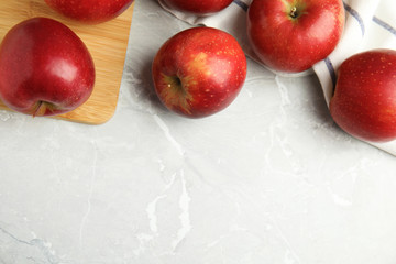 Ripe juicy red apples on grey background, flat lay. Space for text