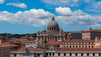 Fototapeta na wymiar Beautiful aerial view on the St. Peter's Basilica ( Famous Roman landmark ) and ancient classical buildings of the Vatican on background of clouds. City of Rome. Italy. Europe