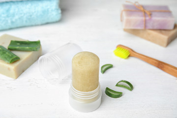 Natural crystal alum deodorant and aloe on white wooden table
