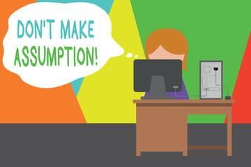 Handwriting text writing Don T Make Assumption. Conceptual photo something that you assume to be case even without proof Young female working office sitting desktop computer office monitor photo