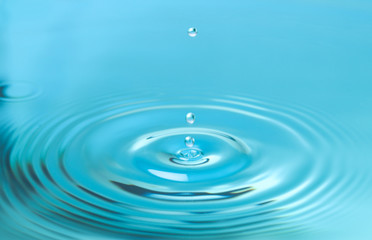 Naklejka na ściany i meble Splash of blue water with drop, closeup