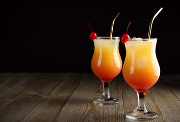 Just made appetizing cocktails Sex on the Beach, black background. Space for text