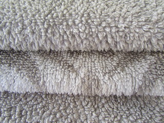 Folded towels close-up. Terry towel texture. Design element.