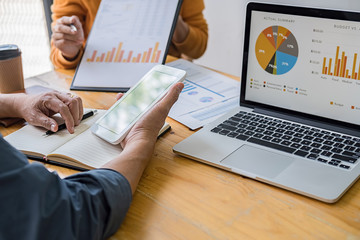 Business concept. Business people discussing the charts and graphs showing the results of their successful teamwork.