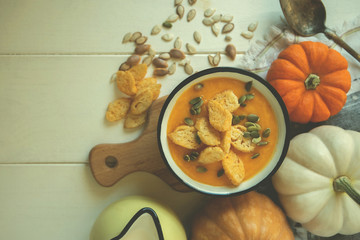 Healthy vegetarian seasonal Fall food cooking background. Flat-lay of autumn vegetables and spice over wooden background, top view, copy space. Clean eating, alkaline diet food.