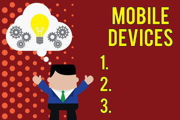 Writing note showing Mobile Devices. Business concept for A portable computing device like smartphone tablet computer Man hands up imaginary bubble light bulb working together