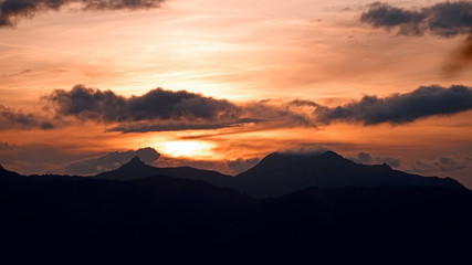 beautiful sunset in the mountains with orange sky and view to the alps