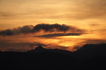 beautiful sunset in the mountains with orange sky and view to the alps