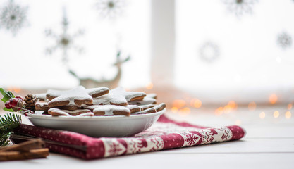 Vintage Christmas background. Christmas homemade gingerbread cookies on plate on white wooden table. Christmas, winter, new year concept. Copy space.