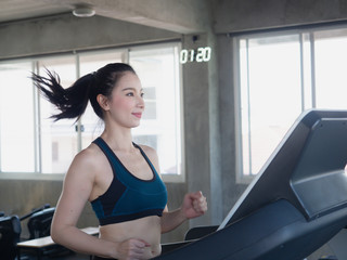 Fototapeta na wymiar asian sports women on running in gym,fitness concept