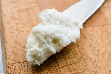 Ricotta Cheese with Knife on Wooden Board Ready to Eat.