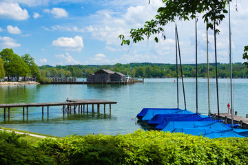 Pier with boats and little houses on the lake Starnberg in Germany