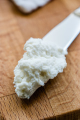 Ricotta Cheese with Knife on Wooden Board Ready to Eat.