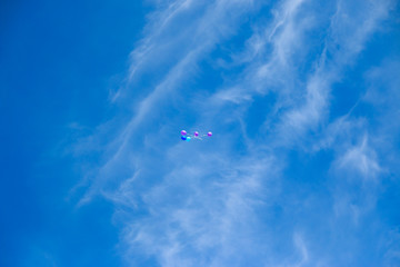 Flying balloons with blue sky background.