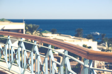 Blurred view of sea resort with hand rails in the foreground