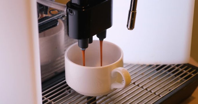 making coffee in the coffee machine. woman's hand takes a Cup of coffee