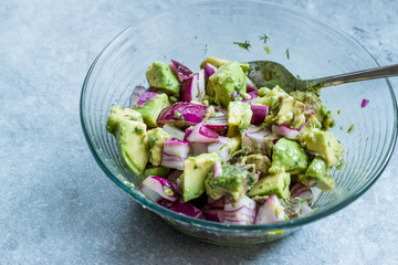 Avocado Salad with Red Onions in Glass Bowl.