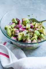 Avocado Salad with Red Onions in Glass Bowl.