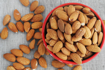A bowl with almond on a wooden table