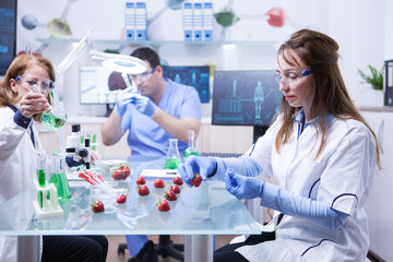 Middle age female scientis wearing protection gloves in a research lab