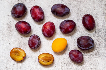 Plums and apricot on a light background. Summer vitamins