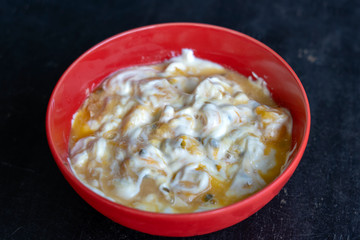 Mango, passionfruit and yogurt brulee. Fruit dessert on breakfast with wedges of perfectly ripe in season mangoes covered fresh passion fruit pulp