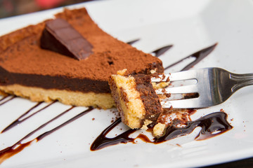Truffle filling Tart portion decorated with cocoa powder and chocolate