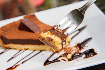 Truffle filling Tart portion decorated with cocoa powder and chocolate