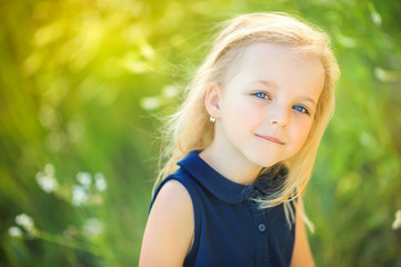 lovely cute little girl playing outdoors at sunset, walking on the field, happy childhood